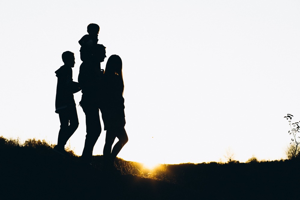 silhouette-family-walking-by-sunset-time